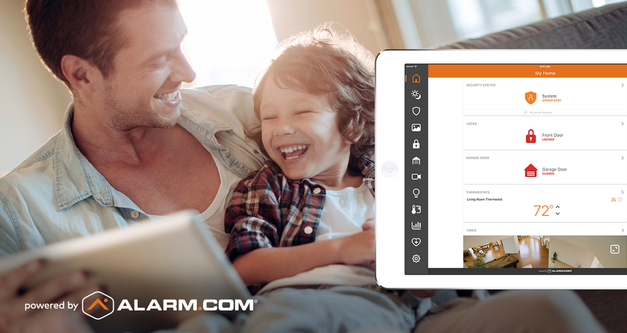 father and son sitting together, looking at a tablet. In the foreground is an Alarm.com tablet interface.